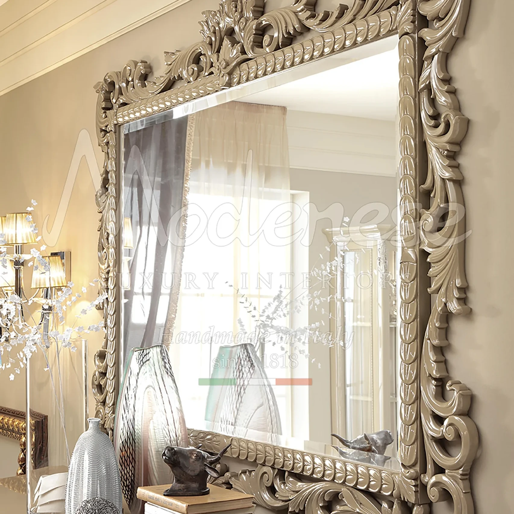 A meticulously crafted wood-carved mirror designed by Modenese Interiors to add a touch of elegance to any space.